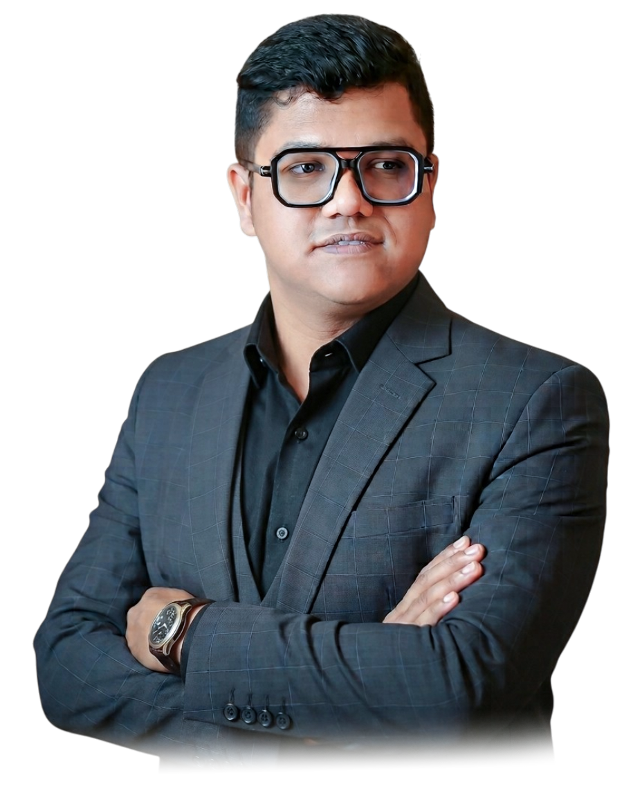Nirjhar Khan, Creative Team Lead and graphic designer, standing with arms crossed in a charcoal checked blazer